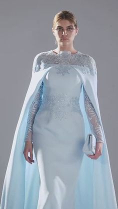 Elegant Cape Dress For Banquet, Elegant Embroidered Gown For Banquet, Evening Dress With Embroidery And Cape Sleeves, Evening Dress With Embroidered Cape Sleeves, Elegant Embroidered Banquet Gown, Embroidered Evening Dress With Cape Sleeves, Elegant Floor-length Evening Dress For Ceremony, Elegant Gown With Intricate Embroidery And Cape Sleeves, Elegant Gown With Embellished Cape Sleeves