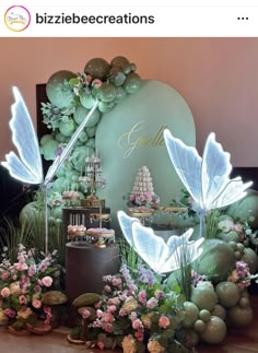 a table topped with lots of flowers and fairy decorations