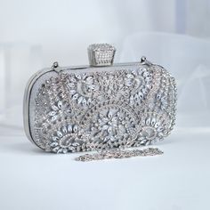 New to our Millennium collection, This beautiful romantic Silver Crystal Floral Leaves bridal clutch bag is made of very fine quality of crystal,  rhinestones, fabric and metal and it comes with Chain 46 inches long os cross body bag Detachable chain for your Big day! The Clutch measure about 7.5 inches long, 4 inches wide and thickness of the bag is 1.8 inches  ► ABOUT YOUR ORDER * All items are neatly packaged in our beautiful jewelry boxes and elegant organza bags. * All items are 100% gift-r Elegant Handheld Evening Bag For Events, Elegant Handheld Bags For Wedding Guest, Elegant Handheld Bag For Wedding Guest, Silver Pouch Evening Bag For Events, Glamorous Clutch Shoulder Bag For Wedding Guest, Silver Pouch Shoulder Bag For Evening, Luxury Bags For Wedding Guests, Glamorous Evening Bag For Wedding, Luxury Openable Clutch For Wedding