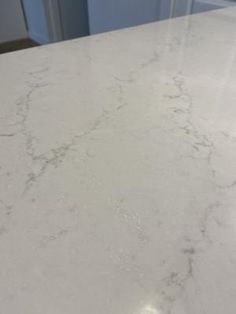 a white marble counter top in a kitchen