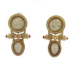 "Vintage White Lava  Stone carved into Cameos Dangle/Drop Earrings with natural  Rubies and Citrine  Set into Brushed/Matte 14k Yellow Gold Ornate Settings Omega Back RARE FIND! These earrings are showstoppers!  Four vintage lava stone cameos are uniquely set into solid gold with a moveable bottom half of the earrings. The cameos are very nicely carved & have nice detailing - there are some small dark marks  which are natural in the stone. The marks do not detract from the overall beauty of these stunning earrings- just add to the uniqueness . Metal Content: 14K Gold 4 Carved Cameos: White Lava Stone Approximate Size of Cameos: Two 9mm round,  Two 12mm x 9mm Gemstones: 4 Ruby Cabochon - 3.4mm 2 Square Citrine - 3.3mm Earring Measurements Length: 1 5/8\" (41mm) Width:  15/16\" (24mm) Weight Roman Design, Round Two, Dark Mark, Lava Stone, Stunning Earrings, Star Earrings, Stone Earrings, Vintage Watches, Beautiful Earrings