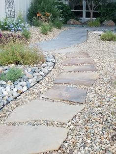 a stone path in front of a house