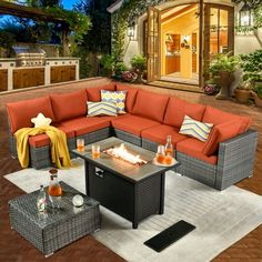 a fire pit sitting on top of a patio next to a couch and coffee table