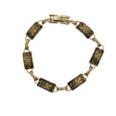 Vintage Damascene gold and black enamel bracelet has rectangle panels with flowers. Bracelet measures 7 inches length and has fold over clasp. Each panel measures ½ inch long.  Very nice condition. Please see photos for more details. All items are vintage that are preowned. All of the items may show some form of wear due to their age. Please kindly remember that these items are anywhere from 30-80 years old. I make every attempt to clearly describe the item, including any flaws or wear to the be Rectangular Metal Bracelets Engraved, Antique Gold Rectangular Bracelet, Vintage Black Enamel Rectangular Jewelry, Vintage Rectangular Black Enamel Jewelry, Formal Rectangular Gold Bracelet, Vintage Gold Enamel Bracelets, Vintage Enamel Jewelry With Rectangular Shape, Vintage Rectangular Enamel Jewelry, Engraved Rectangular Gold Bracelet For Formal Occasions