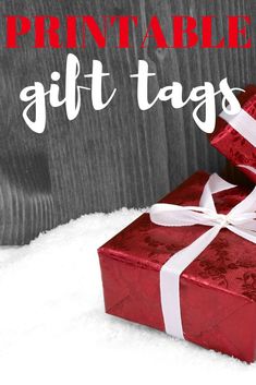 a red gift box sitting in the snow with text overlay that reads printable gift tags