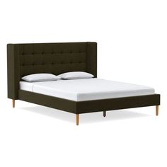 the headboard and foot board are upholstered on this bed with white sheets