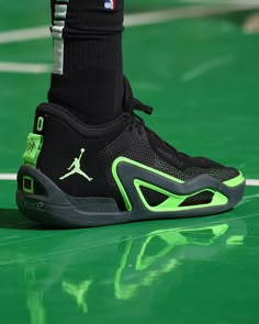 the shoe of a basketball player wearing black and neon green