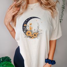 This Floral Crescent Moon Shirt is a soft-washed, garment-dyed fabric brings extra coziness to your wardrobe while the relaxed fit makes it an excellent daily choice. The double-needle stitching throughout the tee makes it highly durable while the lack of side-seams helps the shirt retain its tubular shape. .: 100% ring-spun cotton .: Medium fabric (6.1 oz/yd² (206.8 g/m .: Relaxed fit .: Sewn-in twill label Cotton Summer Tops With Moon Print, Casual Spring Tops With Moon Print, Casual Moon Print Tops For Spring, Cotton T-shirt With Moon Print In Relaxed Fit, Relaxed Fit Cotton T-shirt With Moon Print, Cotton Moon Print T-shirt In Relaxed Fit, Trendy Spring Tops With Moon Print, Casual Cotton T-shirt With Moon Print, Casual Relaxed Fit T-shirt With Moon Print