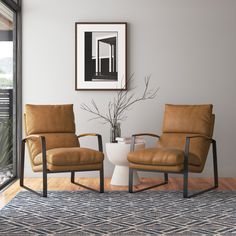 two brown chairs sitting next to each other on top of a wooden floor