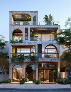 an apartment building with many balconies and plants on the balconys at dusk