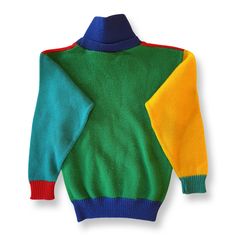 A truly charming vintage sweater in bright red, blue, teal, yellow, and green. Button on the collar, which can be worn up or folded down. Excellent vintage condition 100% acrylic Machine wash & dry or lay flat to dry Retro Winter Sweater With Color Matching, Retro Color Block Sweater For Winter, Retro Color Block Winter Sweater, Retro Winter Color Block Sweater, Retro Green Patchwork Sweater, Multicolor Fall Sweater For Playtime, Retro Green Knitted Sweater, Vintage Multicolor Color Block Sweater, Playful Multicolor Sweater For Playtime