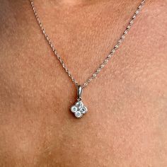 Add a touch of luck and elegance to your attire with our exquisite 14KT white gold diamond clover pendant. This delightful piece features a total of .29CT in natural diamonds, meticulously set to form the intricate clover design. Measuring 7.35MM in diameter, the pendant exudes sophistication and style. Included is a 16-inch chain that can be adjusted to 18 inches, providing versatility in wearing options. Secured with a lobster lock, this pendant is a perfect blend of beauty and functionality, White Gold Flower Pendant Diamond Necklace With Brilliant Cut, White Gold Diamond Necklace With Brilliant Cut Flower Pendant, Diamond White Necklace With Flower Pendant And Pave Setting, Classic White Gold Diamond Necklace With Flower Pendant, Classic White Gold Flower Pendant Diamond Necklace, Classic Diamond White Diamond Necklace With Flower Pendant, Classic Diamond White Necklace With Flower Pendant, Classic Diamond White Flower Pendant Necklace, Flower Pendant Diamond Necklace With Diamond Accents