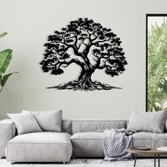 a living room with a large tree wall decal