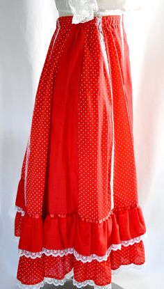 "A vintage 1970s very full pieced or patchwork red and white polka dot and solid red button front prairie skirt with white lace trim and ruffles. The skirt has an elastic waist, which measure 24 inches, stretching to 36 inches. The skirt can be unbuttoned from the hem to about 5 inches below the waist. The skirt is made of vertical panels alternating between the polka dot and solid red. There are rows of white lace running down four seams at the front, two seams in the back. There are two layere Skirt Ruffles, Prairie Skirt, Polka Dot Fabric, Solid Red, Red Button, Dotted Fabric, Red Lace, Embroidered Blouse, Vintage 1970s