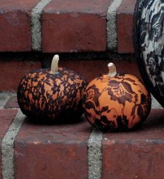 two decorative pumpkins sitting on the steps