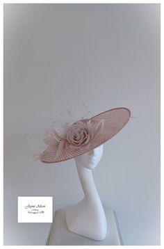 'Striking, upturn slice disc hatinator in salmon pink basket weave sinamay.  Embellished with  a contrasting blush pink rose and blush feather mount with diamond cut coq feathers creating movement and height for this striking headpiece.  Sits on a headband.  The base is also available in other colours. -   Black, Ivory, Navy, Silver, White  Various embellishment colours available.  This item has sold, however, similar pieces can be made in a variety of colours.  Please ask for details.  As every Pink Basket, Wedding Hat, Kentucky Derby Hat, Derby Hat, Royal Ascot, Wedding Hats, Derby Hats, Salmon Pink, Basket Weave