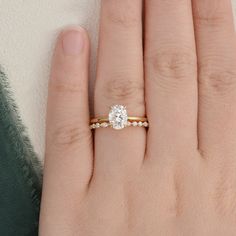 a woman's hand with a diamond ring on it