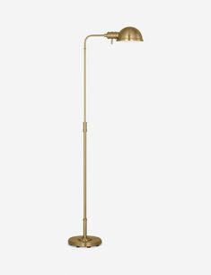 a brass floor lamp on a white background with the light turned off to show its dim lighting