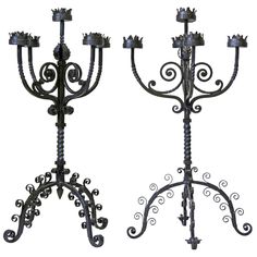 two wrought iron candelabra with candlesticks