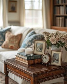 a living room filled with furniture and flowers on top of a table in front of a couch