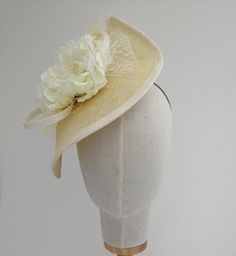 A pretty pale lemon fascinator/hatinator trimmed with a large ivory silk lace flower, sinamay loops and yellow and ivory veiling. It is secured with a fine metal covered headband, which can easily be hidden by your hair if desired. One size fits all Sinamay Fascinator Hat For Spring, Summer Sinamay Headpiece For Races, Spring Sinamay Fascinator Hat, Spring Sinamay Fascinator, Chic Sinamay Fascinator For Summer, Summer Sinamay Fascinator For Races, Adjustable Sinamay Headpiece For Spring, Spring Sinamay Mini Hats For Races, Fitted Cream Wide Brim Costume Hat