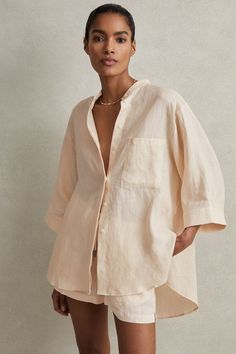 A natural linen look and texture feature in the Winona shirt. Its simple design displays a grandad collar, relaxed ¾ length sleeves, and a split high-low hemline. 100% linen Grandad collar Button-front closure Relaxed sleeves Split high-low hemline Short Sleeve Linen Shirt, Linen Shirts Women, White Linen Shirt, Petite Dresses, Linen Clothes, Workwear Dress, Linen Shirt, Dress Brands, Striped Shirt