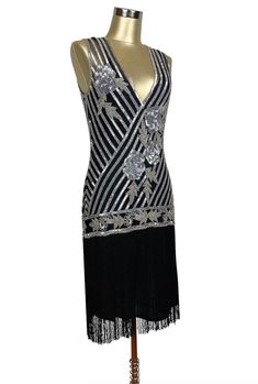 Exciting and romantic - our Artist Gown is the perfect dancing dress! A new take on the iconic fringe dresses of the 1920's, this gown will make you the star attraction at every event. Features include a handbeaded Deco rose design, deep vneck, and long silky fringe. So popular, the black and silver version of this gown was featured in the Academy Award winning film, "The Artist". Sheer, so a slip is recommended. XS....bust 30-34", waist 26-30", hips 34-38", length 49" S....bust 32-36", waist 28 Sequin Flapper Dress For Gala, Fitted Art Deco Dress For Gala, Gatsby Style Evening Dresses For Party Season, Gatsby Style Flapper Dress For Gala Party Season, Evening Gatsby Style Dresses For Party Season, Gatsby Style Dresses For Costume Party, Black Gatsby Style Gala Dresses, Black Gatsby Gala Dress, Glamorous Black Flapper Dress With Fringe