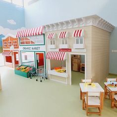 there is a doll house with furniture and accessories in the room that includes tables, chairs, and a shopping cart