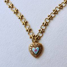 The Blue Guilloche Heart Necklace features an actual vintage, new(old stock) painted blue enamel heart locket on a fancy chain. The chain has an antique golden brass finish but it is new. She’s a special one, for sure. Locket: Hand enameled blue painted flowers; brass. Vintage- new old stock. Chain: Bowdin chain in high quality jewelers brass. 16” in length. This is a studio piece, handmade in our Texas studio. Blue Painted Flowers, Locket Necklace Vintage, Gold Moonstone Ring, Stacked Earrings, Heart Locket Necklace, Gold Heart Necklace, Special One, Painted Flowers, Heart Locket