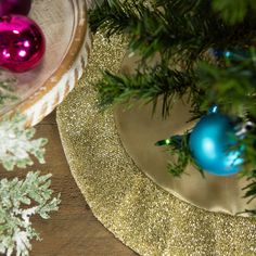 a christmas tree with ornaments on top of it and a plate next to the tree