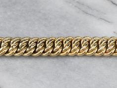 Polished and patterned links give this classic chain bracelet a feminine twist. The curb chain design allows this piece to lay comfortably on the wrist, and makes this bracelet perfect for layering with other pieces! Metal: 18K Yellow Gold Width: 14.0 mm Length: 8 Inches Marks: "750 CM 18K" Stamped on the clasp Luxury Bracelets With Chunky Cuban Link Chain, Formal Cuban Link Bracelet With Chunky Chain, Formal Cuban Link Chunky Chain Bracelet, Formal Chunky Cuban Link Bracelet, Luxury Oval Link Chain Bracelet With Figaro Chain, Luxury Figaro Chain Bracelet With Oval Link, Classic Gold Cuban Link Chunky Chain Bracelet, Luxury Gold Bracelet With Figaro Chain, Classic Yellow Gold Bracelets With Chunky Chain