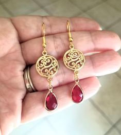 New Handmade Ruby Teardrop Dangle Earrings In each 14Kt yellow gold dangle earring, a pear-shaped Ruby is beautifully set in a bezel setting. These July birthstone earrings are the perfect accent for any occasion ~ Multi faceted stone captures light brilliantly  ~ Drop length measures 2 inches ~ Barrel cut Australian Crystal Ruby teardrop charms ~ Filigree circle charm ~ 14k gold over sterling silver ear hooks stamped .925 ~ Hypoallergenic  ☆I ship daily Monday-Saturday☆ Gift Packaging & Message Red Chandelier Earrings As Gift, Red Teardrop Chandelier Earrings As Gift, Red Nickel-free Chandelier Earrings As Gift, Red Elegant Nickel-free Teardrop Earrings, Red Teardrop Earrings For Gifts, Red Hypoallergenic Drop Earrings, Red Pierced Dangle Chandelier Earrings, Red Teardrop Chandelier Earrings With Ear Wire, Red Dangle Chandelier Earrings