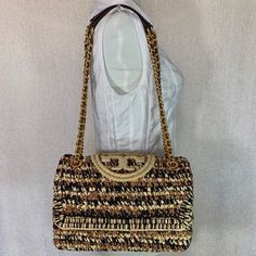 Brand New Never Been Carried. Soft Fleming Convertible Shoulder Bag By Tory Burch. This Bag Is Made Of Soft Raffia And Genuine Leather Trim Dimensions: 10.5" Wide X 7.5" Tall Center X 3.5" Deep. Doubled Chain Straps 12" Drop. Snap On Closure Interior: 1 Zipper Pocket And 1 Slip Pocket 2 Open And 1 Zipper Compartment Fabric Lining. Gold Tone Metalware. Designer Travel Straw Shoulder Bag, Designer Woven Straw Travel Bag, Designer Straw Bag With Gold-tone Hardware, Designer Beige Woven Straw Bag, Designer Woven Straw Bag For Travel, Designer Beige Straw Shoulder Bag, Luxury Gold Straw Bag For Travel, Luxury Straw Tote Shoulder Bag, Designer Brown Bags For Vacation