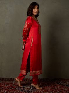 Editor's Note Elevate your ethnic look with our red ari-hand embroidered girija kurta, paired with churidar and a coordinating dupatta. This ensemble combines traditional charm with intricate hand embroidery, perfect for special occasions and celebrations. Fabric: Silk satin Color: Red Components: Kurta, churidar and dupatta Occasion: Festive Note: Product colour may slightly vary due to photographic lighting sources Care: Dry clean only About the DesignerRi Ritu Kumar is one of India’s foremost Churidar With Resham Embroidery In Art Silk, Chanderi Kurta With Resham Embroidery For Navratri, Cotton Silk Straight Kurta With Embroidered Border, Art Silk Churidar With Resham Embroidery, Straight Kurta Churidar With Resham Embroidery In Art Silk, Straight Chanderi Kurta With Embroidered Border, Bollywood Style Sets With Resham Embroidery And Straight Kurta, Straight Kurta Salwar Kameez With Embroidered Border, Designer Palazzo Set With Embroidered Border