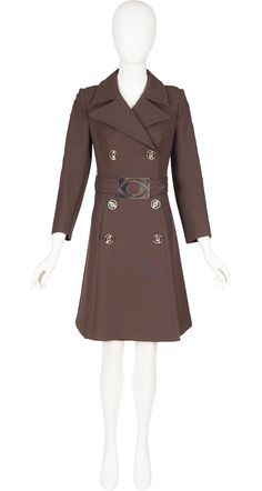 "This 1960s mod double-breasted brown wool coat is missing its designer label, but it's the same high quality that you would see from Cardin or other influential designers of the era. It has large pointed lapels, a pocket on each side, and a 22\" vent in the back. The belt has a large silver-tone metal buckle in the shape of an eye. It fastens with silver plastic round buttons, and has three matching decorative buttons on each cuffs. There are a few minor scratches on the belt buckle but the coat is otherwise in excellent condition, professionally dry-cleaned and ready to wear. Measurements: Bust - 32\" Waist - 29\" Hips - 34\" Shoulders - 14.5\" Sleeves - 20.5\" Length - 37\" IMPORTANT NOTE FOR CANADIAN SHOPPERS: There is a 15% shipping fee that is automatically applied to Canadian orders Brown Wool Coat With Lapel Collar For Office, Brown Notch Lapel Pea Coat For Office, Elegant Fitted Brown Wool Coat, Designer Brown Blazer With Buttons, Fitted Brown Wool Coat With Lapel Collar, Brown Double-breasted Wool Coat For Formal Events, Brown Double-breasted Wool Coat For Formal Occasions, Brown Fitted Wool Coat With Lapel Collar, Elegant Brown Pea Coat With Hidden Button Closure