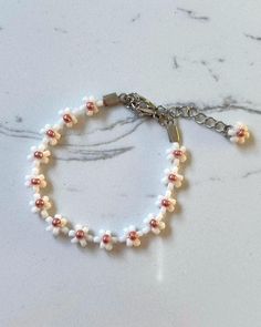 Looking for the perfect bridesmaid gift? Get your besties matching by wearing this cute matte white and pink flower beaded bracelet. You can even size up to style as an anklet! Inspired by the delicate romance of weddings, this beauty is all about love, friendship, and good vibes. Explore more at Dainty and Shine ✨  Size and details: Measuring 15cm with a 4.5cm extender chain, it offers a perfect fit for any wrist.  8/0 seed beads, and stainless steel lobster clasp. Care instructions:  To keep i White Dainty Beaded Bracelets For Bridesmaid Gift, White Beaded Bracelets For Bridesmaid Gift, Dainty White Beaded Bracelets For Bridesmaids, White Beaded Bracelet For Bridesmaid Gift, Adjustable White Bracelet With Flower Decoration, Adjustable White Jewelry With Flower Decoration, White Dainty Beaded Bracelet With Flower Charm, Dainty White Beaded Bracelet With Flower Charm, White Flower Charm Bracelet For Wedding