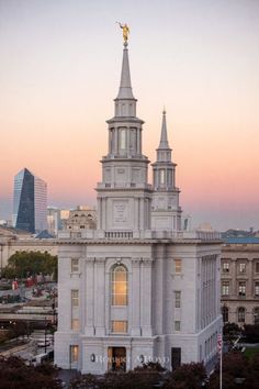 a large white building with two spires on top