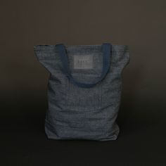 a gray bag sitting on top of a black table