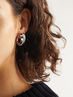 Bottega Veneta's sculptural designs are often inspired by modernist art. These hollowed-out earrings are crafted from sterling silver and modeled after classic hoops. Modern White Gold Earrings With Shiny Finish, Modern Metal Pierced Huggie Earrings, Modern Sterling Silver Earrings With Shiny Finish, Modern Twist Sterling Silver Hoop Earrings, Contemporary Sterling Silver Hoop Jewelry, Modern Hoop Wrap Earrings, Modern Pierced Hoop Wrap Earrings, Modern Small Hoop Earrings In White Gold, Modern Twist Sterling Silver Hoop Earrings For Pierced Ears