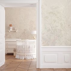 a baby's crib in the corner of a room with wallpaper on the walls