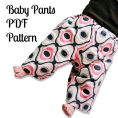 a baby pants pattern with black and pink circles on the bottom, in front of a white background