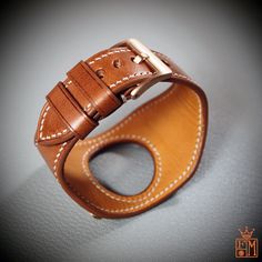 "This Applewatch watchband uses Italian Vegetable tanned leather in Whiskey color and is hand stitched throughout. A soft calfskin lining hugs your wrist and a high quality buckle and applewatch adapters are included. Can be sized for any applewatch! Just supply the series and size ( 38, 40 44mm, etc..) and also the finish ( polished, matte, gold, black, etc..) I'll need your wrist size per the supplied pic. I Can size it for men or women Can be made many finishes and colors. Just ask! - 1-7/8\" Luxury Leather Strap Bracelets For Everyday Use, Timeless Leather Watch With Bracelet Strap, Timeless Leather Watch Bands, Brown Leather Bracelet For Formal Occasions, Classic Leather Watch Bands With Palladium Hardware, Timeless Leather Watch Bands With Bracelet Strap, Timeless Leather Watch Band With Bracelet Strap, Timeless Leather Bracelet Strap Watch Bands, Formal Leather Watch Bands With Palladium Hardware