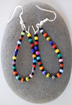 this is a handmade pair of rainbow beaded earrings. Multicolor Teardrop Jewelry With Colorful Beads, Multicolor Dangle Beads With Ear Wire, Handmade Rainbow Drop Earrings, Rainbow Round Beads Jewelry With Ear Wire, Rainbow Beaded Drop Earrings, Rainbow Colorful Beads Drop Earrings, Rainbow Colorful Bead Drop Earrings, Rainbow Earrings With Colorful Round Beads, Handmade Rainbow Dangle Earrings