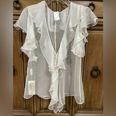 Dolce & Gabbana Silk Sheer Blouse Sheer 100% Silk Blouse In White Eu 44 / Us Size 10. Loose Flowing Style. Can Be Tied Tighter Or Loose. Darted Front Seems Flowing Ruffles Down Center Front, Around Neck And Sleeves. Can Be Worn Loose And Flowing Over A Strapless Top. Beautiful Romantic Flowing Silhouette. Flaws : A Few Black Stains; Please See Photos Minor Pulls As Fabric Is Very Delicate. Sold As Is Elegant Short Sleeve Beach Blouse, Elegant Fitted Blouse For Beach, White Sheer Silk Blouse, Elegant Ruffled Blouse For Beach, Elegant Ruffled Blouse For The Beach, Elegant Flowy Beach Blouse, Elegant Flowy Blouse For Beach, Elegant Sheer Tops For Beach, Elegant Sheer Tops For The Beach