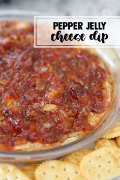 pepper jelly cheese dip in a glass bowl with crackers on the side and text overlay