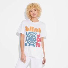 The Women's Blink 182 Short Sleeve Graphic T-Shirt in white is ideal for music lovers and fashion enthusiasts alike. This t-shirt features a graphic design of Blink 182’s iconic band logo for an added rock 'n’ roll flair to your ensemble. It is crafted from lightweight fabric for a comfortable and breathable feel. Whether you're hitting the streets or chilling with friends, the women's Blink 182 short sleeve graphic t-shirt in white is sure to make a statement. 90s Style White Graphic Print T-shirt, White Hip Hop T-shirt For Concert, Spring Band Logo Graphic Tee, Trendy Band Logo T-shirt For Summer, 90s White Graphic Print T-shirt, Casual T-shirt With Logo Print For Concerts, 90s White Fan Merchandise T-shirt, White Screen Print Tops For Concert, Trendy Band Logo T-shirt For Streetwear