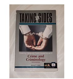 the book taking sides showing two hands holding each other with handcuffs on their wrists,