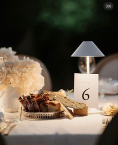 the table is set with bread, cheese and wine for an elegant wedding breakfast or reception