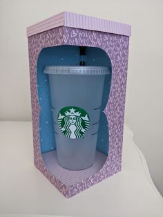 an open cardboard box with a starbucks cup inside