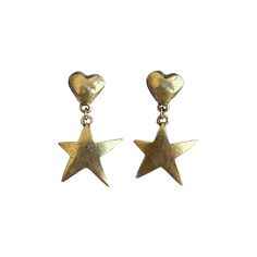 Earrings for a STAR! The Billie earrings sport hand-carved 12k antiqued gold plated pewter heart studs with stainless steel posts and have mini 12k antiqued gold plated pewter star charms adorning them. They'll have you shimmering all night long! Avoid contact with water, perfumes, and lotions. Romcom Outfits, August Birthstone Jewelry, July Birthstone Jewelry, Jewelry Ring Box, Pearl Jewellery Earrings, Earring Sale, Evil Eye Jewelry, Heart Studs, Gold Star